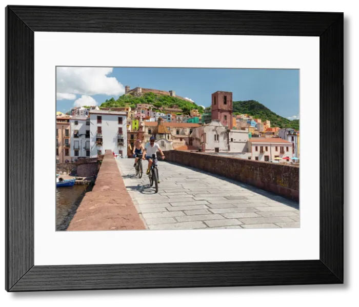 Framed Print : Cyclists on a bridge, Bosa, Oristano district, Sardinia, Italy Framed Print : Cyclists on a bridge, Bosa, Oristano district, Sardinia, Italy