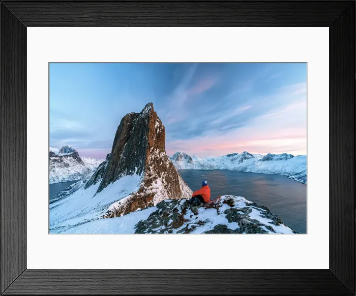 Framed Print : One person contemplating the sky at sunset sitting on a snowy ridge on Segla mountain, Senja, Troms county, Norway