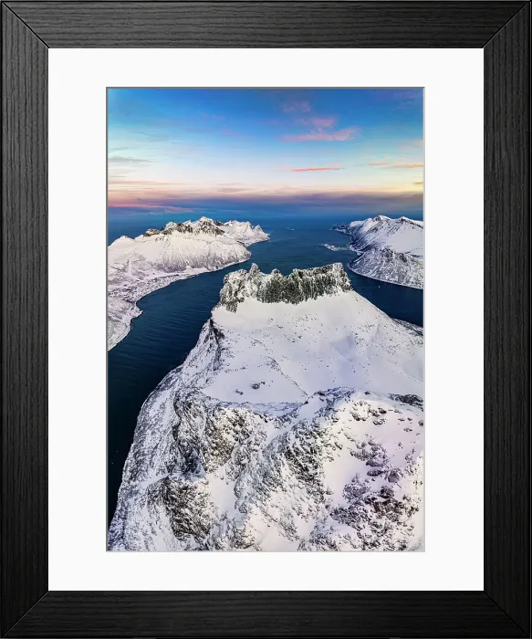 Framed Print : Romantic sunrise over the snowy peak of Grytetippen mountain along the icy sea, aerial view, Ornfjord, Senja, Troms, Norway Framed Print : Romantic sunrise over the snowy peak of Grytetippen mountain along the icy sea, aerial view, Ornfjord, Senja, Troms, Norway
