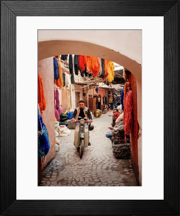 Framed Print : Man on a scooter through the colorful streets of the medina of Marrakech Framed Print : Man on a scooter through the colorful streets of the medina of Marrakech