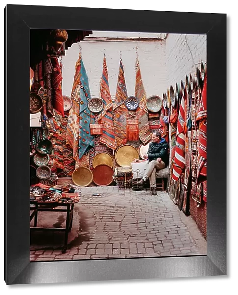 Seller of carpets and fabrics in the souk, Marrakech
