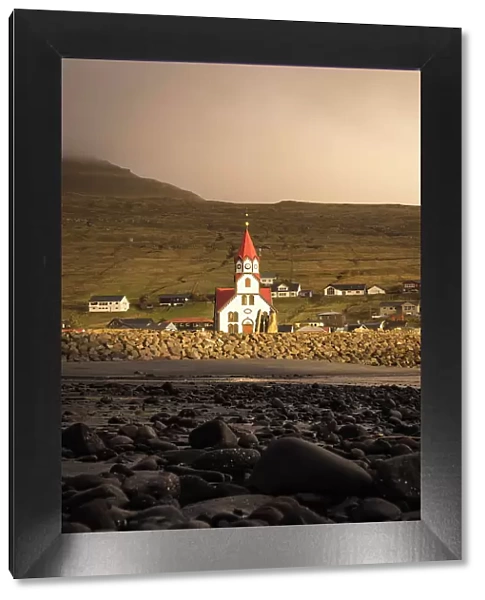 The church in the village of Sandavagur at sunset. Island of Vagar. Faroe Islands