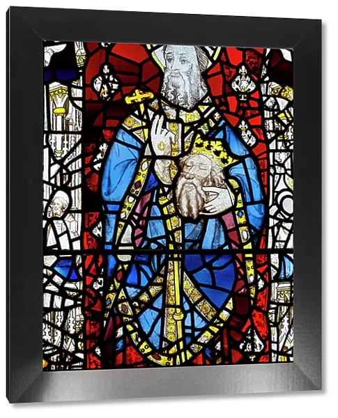 UK, England, English; British; York, York Minster, medieval stained glass; 15th century window; Seventh Century abbot of Lindisfarne St. Cuthbert carrying head of St. Oswald