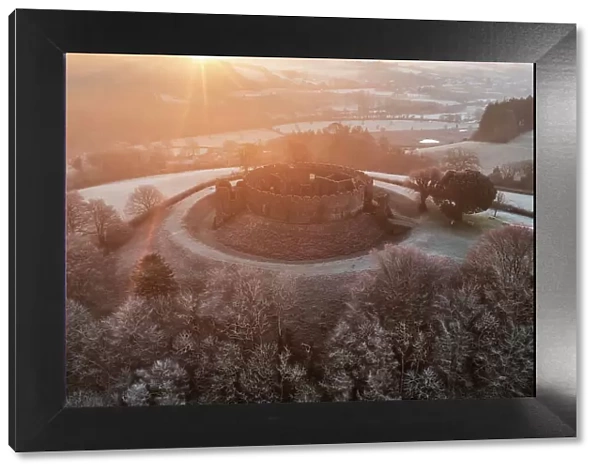 Sunrise over Restormel Castle on a chill, frosty morning, Lostwithiel, Cornwall, England. Winter (January) 2023