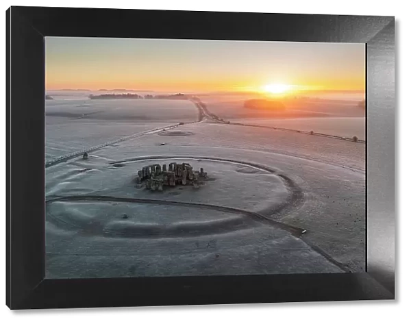 Aerial view of Stonehenge at sunrise on a frosty winter morning, Amesbury, Wiltshire, England. Winter (February) 2023