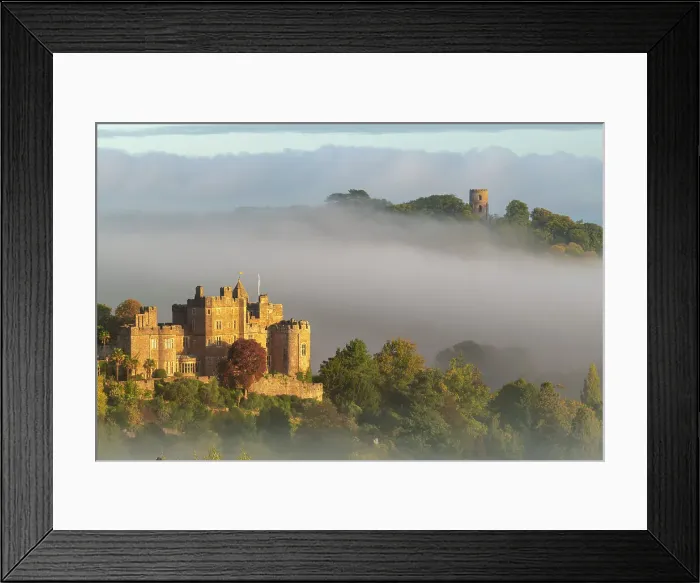 Framed Print : Dunster Castle and Conygar Tower emerging from morning mist, Dunster, Exmoor National Park, Somerset, England. Autumn (October) 2022