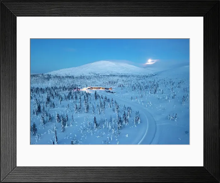 Framed Print : Aerial view of a snowy mountain road in the frozen forest nearby a ski area at dusk, Yllastunturi National Park, Lapland, Finland Framed Print : Aerial view of a snowy mountain road in the frozen forest nearby a ski area at dusk, Yllastunturi National Park, Lapland, Finland