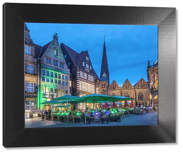 Street cafes on the market square with Church Unser Lieben Frauen in the evening, Bremen, Germany