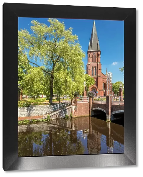 Saint Antonius Church on the main canal in the old town of Papenburg, Emsland, Lower Saxony, Germany