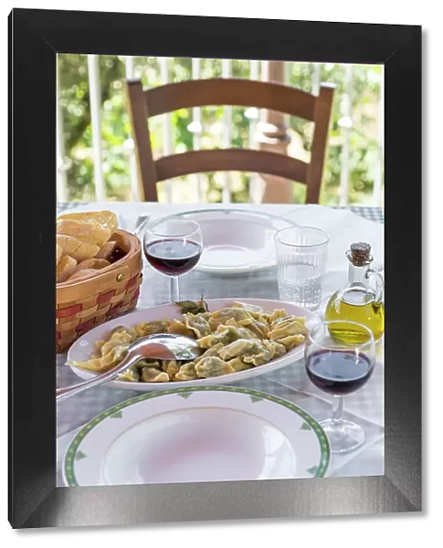 europe, Italy, Liguria, a lunch table in an agriturismo with home made ravioli and red wine