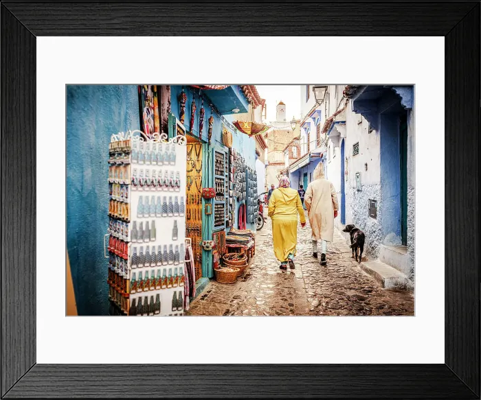 Framed Print : Local people walking in the street markets in the old medina of Chefchaouen, Morocco Framed Print : Local people walking in the street markets in the old medina of Chefchaouen, Morocco