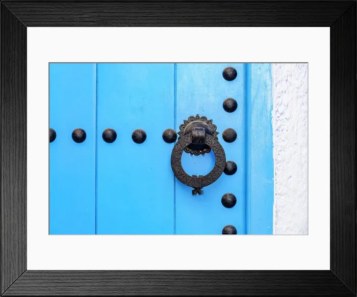 Framed Print : Close up of blue knobbed doorway on white wall background in the old alleys of Medina, Chefchaouen, Morocco Framed Print : Close up of blue knobbed doorway on white wall background in the old alleys of Medina, Chefchaouen, Morocco