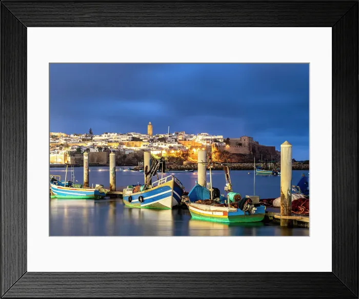 Framed Print : Boats moored along the waterfront with the old medina on background at dusk, Rabat, Morocco Framed Print : Boats moored along the waterfront with the old medina on background at dusk, Rabat, Morocco