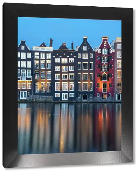 Dancing houses near river at twilight, Damrak, Amsterdam, Netherlands