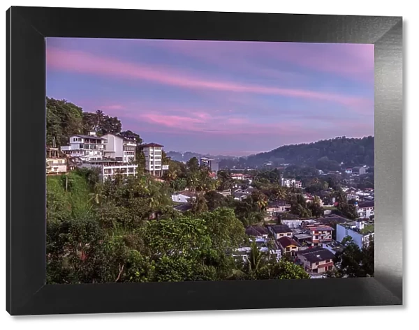 Asia, Sri Lanka, Central Province, Kandy, skyline of Kandy city at dusk showing buildings and surrounding hills
