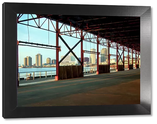 The skyline of New Orleans is visible thru the steel frame of an old factory building located in the newly developed Crescent Park on the banks of the Mississippi River in New Orleans. Louisiana, USA