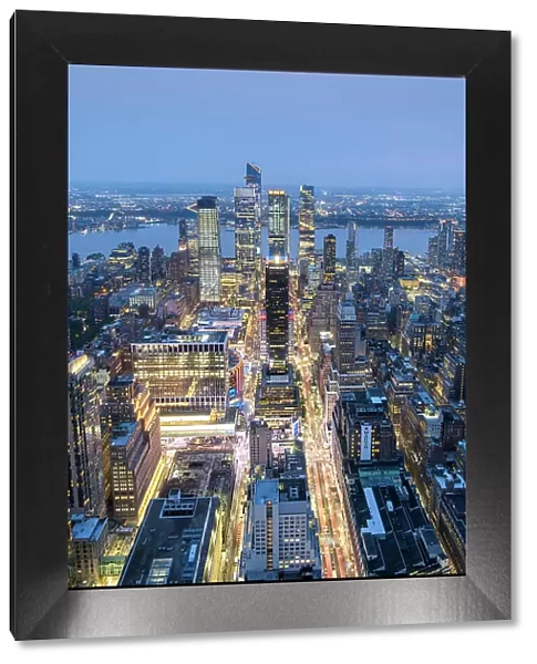 USA, New York, NYC; Elevated View of Hudson Yards, PENN 1 & Hudson River with New Jersey; illuminated buildings: One Penn Plaza
