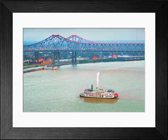 Framed Print : Steamboat paddles out of the Port of New Orleans on the Mississippi River. The Crescent City Connection Bridges, Louisiana, USA Framed Print : Steamboat paddles out of the Port of New Orleans on the Mississippi River. The Crescent City Connection Bridges, Louisiana, USA