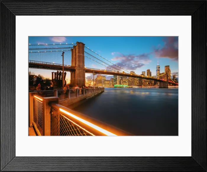 Framed Print : USA, New York City, people enjoying the view of the Brooklyn bridge and the skyscrapers of the financial district illuminated and reflecting in the river Framed Print : USA, New York City, people enjoying the view of the Brooklyn bridge and the skyscrapers of the financial district illuminated and reflecting in the river
