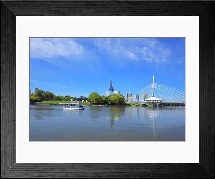 Framed Print : Winnipeg skyline with Canadian Museum for Human Rights and Esplanade Riel bridge with tour boat on the Red River, Winnipeg, Manitoba, Canada Framed Print : Winnipeg skyline with Canadian Museum for Human Rights and Esplanade Riel bridge with tour boat on the Red River, Winnipeg, Manitoba, Canada