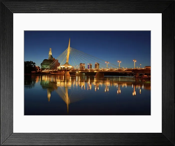 Framed Print : Skyline of the City of Winnipeg reflected in the Red River featuring the Canadian Museum for Human Rights (CMHR) and the Esplanade Riel Bridge at dusk, Winnipeg, Manitoba, Canada Framed Print : Skyline of the City of Winnipeg reflected in the Red River featuring the Canadian Museum for Human Rights (CMHR) and the Esplanade Riel Bridge at dusk, Winnipeg, Manitoba, Canada