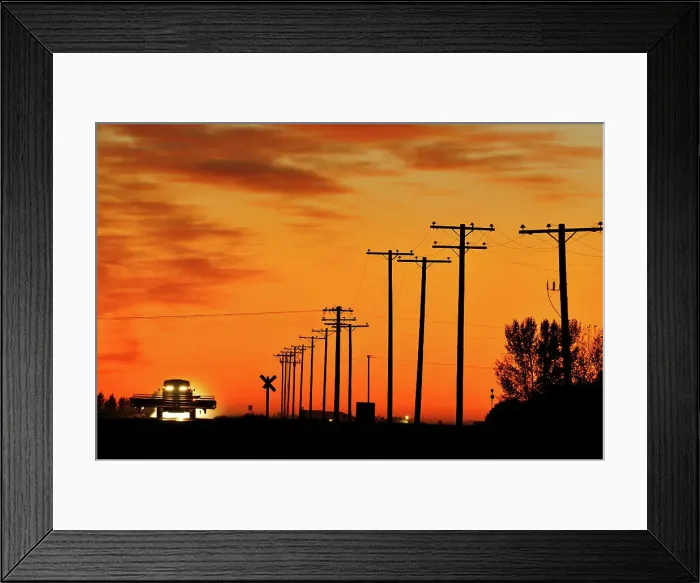 Framed Print : Combine moving down the road at sunset Tuxford, Saskatchewan, Canada