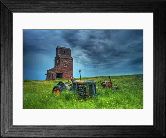 Framed Print : Grain elevators and old tractors in ghost town Bents, Saskatchewan, Canada Framed Print : Grain elevators and old tractors in ghost town Bents, Saskatchewan, Canada