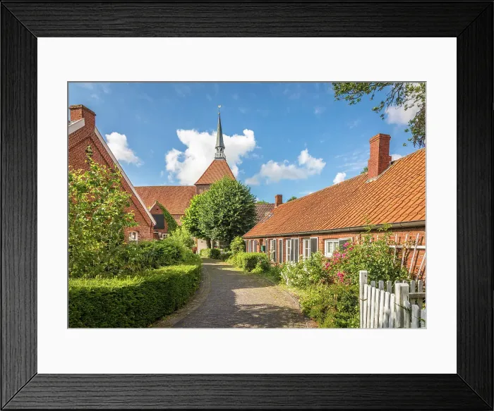 Framed Print : Alley and church in the village of Rysum, Krummhoern, East Frisia, Lower Saxony, Germany Framed Print : Alley and church in the village of Rysum, Krummhoern, East Frisia, Lower Saxony, Germany