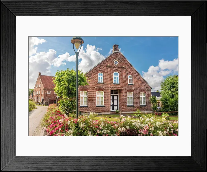 Framed Print : Historic brick house and lush floral decorations in the village of Rysum, Krummhoern, East Frisia, Lower Saxony, Germany Framed Print : Historic brick house and lush floral decorations in the village of Rysum, Krummhoern, East Frisia, Lower Saxony, Germany