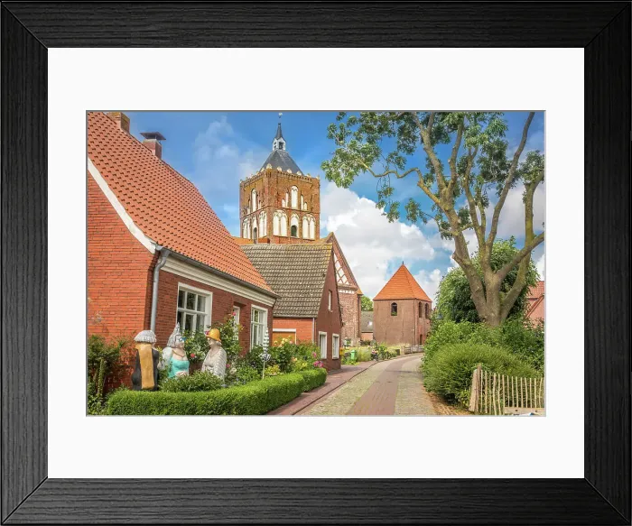 Framed Print : Village street and Kreuzkirche Pilsum, Krummhoern, East Frisia, Lower Saxony, Germany Framed Print : Village street and Kreuzkirche Pilsum, Krummhoern, East Frisia, Lower Saxony, Germany