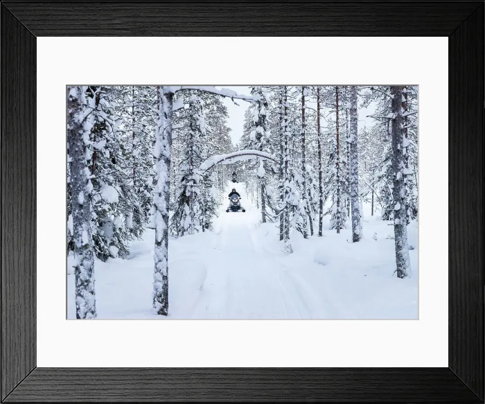 Framed Print : Snowmobiles on forest road, Kuusamo, Finland