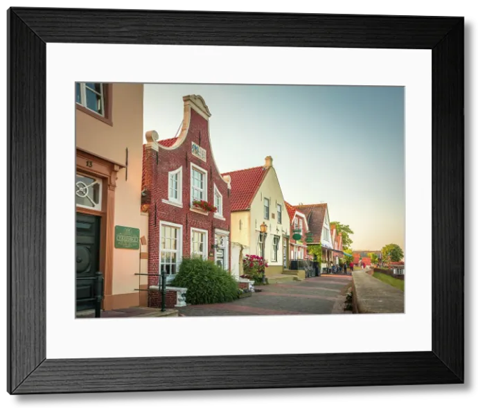 Framed Print : Historic brick houses at the harbor in Greetsiel, East Frisia, Lower Saxony, Germany Framed Print : Historic brick houses at the harbor in Greetsiel, East Frisia, Lower Saxony, Germany