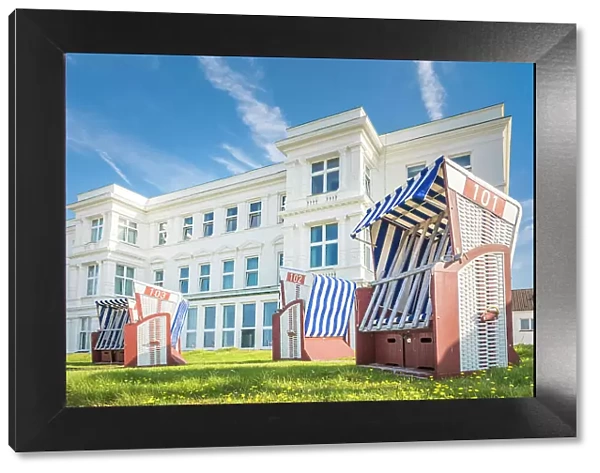 Beach chairs in front of a historic hotel house on the western beach of Norderney, East Frisian Islands, East Frisia, Lower Saxony, Germany