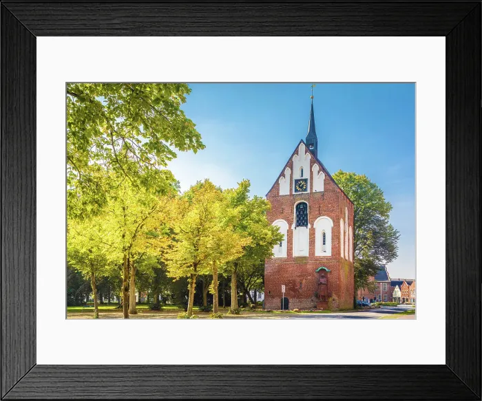 Framed Print : Early Gothic bell tower of the Ludgeri Church on the market square in Norden, East Frisia, Lower Saxony, Germany Framed Print : Early Gothic bell tower of the Ludgeri Church on the market square in Norden, East Frisia, Lower Saxony, Germany
