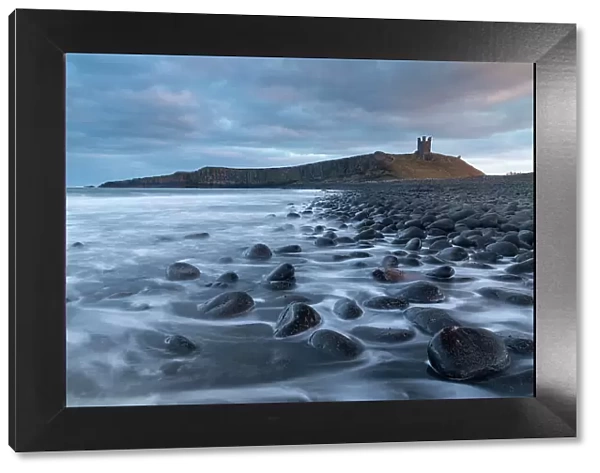 Dunstanburgh Castle from the rocky shores of Embleton Bay, Northumberland, England. Winter (February) 2018