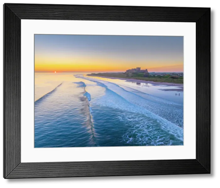 Framed Print : UK, England, Northumberland, Bamburgh, Bamburgh Beach, Bamburgh Castle at sunrise