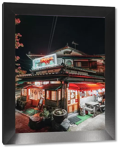 Typical Japanese inn restaurant with neon lights at night, Kyoto district, Japan