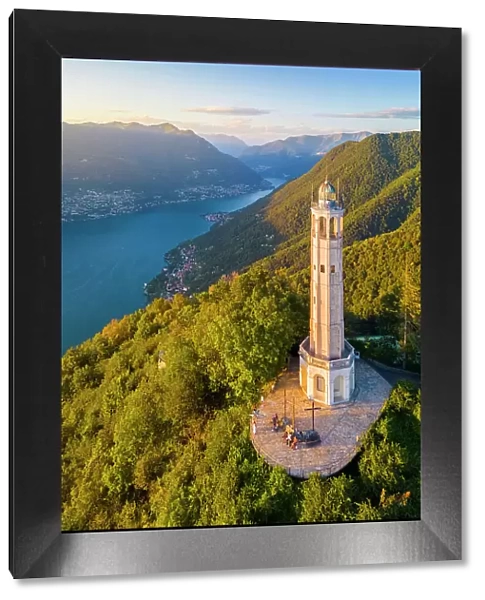 Aerial view of the Faro Voltiano (Volta Lighthouse) of Brunate overlooking Como and Como Lake in summer at sunset. Brunate, Province of Como, Lombardy, Italy