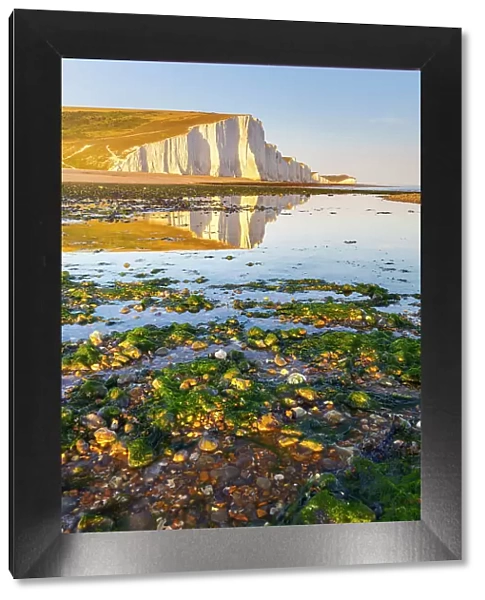 Seven Sisters reflected on Cuckmere Haven beach at sunset, Sussex, England, United Kingdom