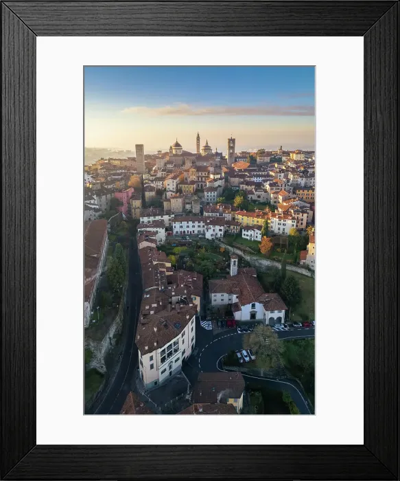 Framed Print : View of the rooftops, churches and towers of the Upper Town (Città Alta) of Bergamo city at sunrise. Bergamo, Lombardy, Italy Framed Print : View of the rooftops, churches and towers of the Upper Town (Città Alta) of Bergamo city at sunrise. Bergamo, Lombardy, Italy