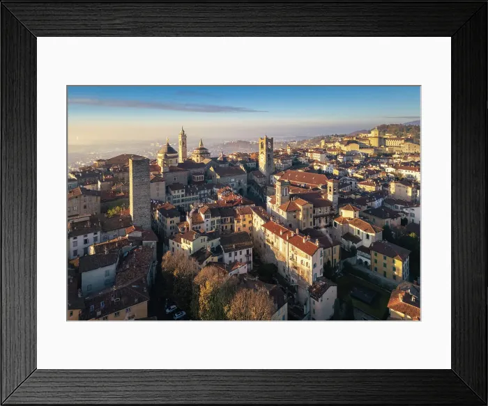 Framed Print : View of the rooftops, churches and towers of the Upper Town (Città Alta) of Bergamo city at sunrise. Bergamo, Lombardy, Italy Framed Print : View of the rooftops, churches and towers of the Upper Town (Città Alta) of Bergamo city at sunrise. Bergamo, Lombardy, Italy