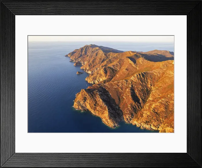 Framed Print : Aerial view of the rugged coast of the island of Capraia at sunset, Tuscan Archipelago National Park, Livorno province, Tuscany, Italy Framed Print : Aerial view of the rugged coast of the island of Capraia at sunset, Tuscan Archipelago National Park, Livorno province, Tuscany, Italy