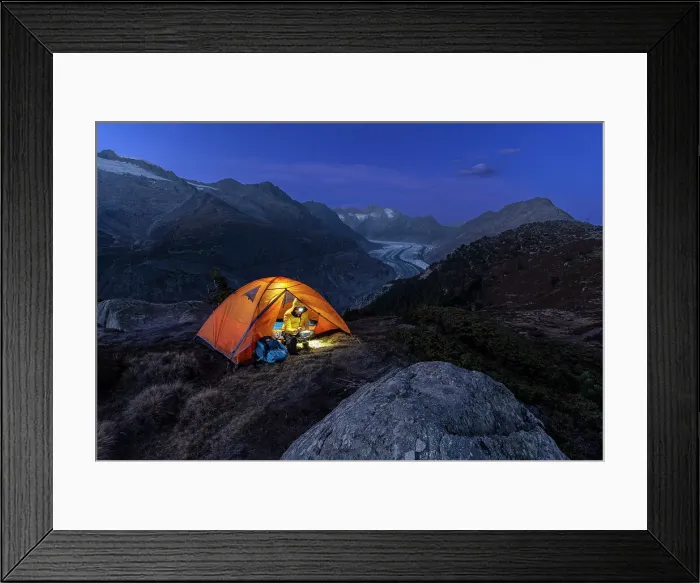 Framed Print : Man with head torch preparing meals outside the tent pitched above the Aletsch glacier at dusk, Bernese Alps, Valais canton, Switzerland (MR) Framed Print : Man with head torch preparing meals outside the tent pitched above the Aletsch glacier at dusk, Bernese Alps, Valais canton, Switzerland (MR)