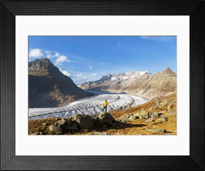 Framed Print : A hiker standing on top of a rock looking at the view of the Aletsch glacier, Bernese Alps, Valais canton, Switzerland (MR) Framed Print : A hiker standing on top of a rock looking at the view of the Aletsch glacier, Bernese Alps, Valais canton, Switzerland (MR)