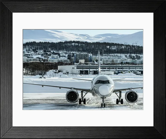 Framed Print : Commercial aircraft in the frozen airport of Tromso in winter, Norway Framed Print : Commercial aircraft in the frozen airport of Tromso in winter, Norway
