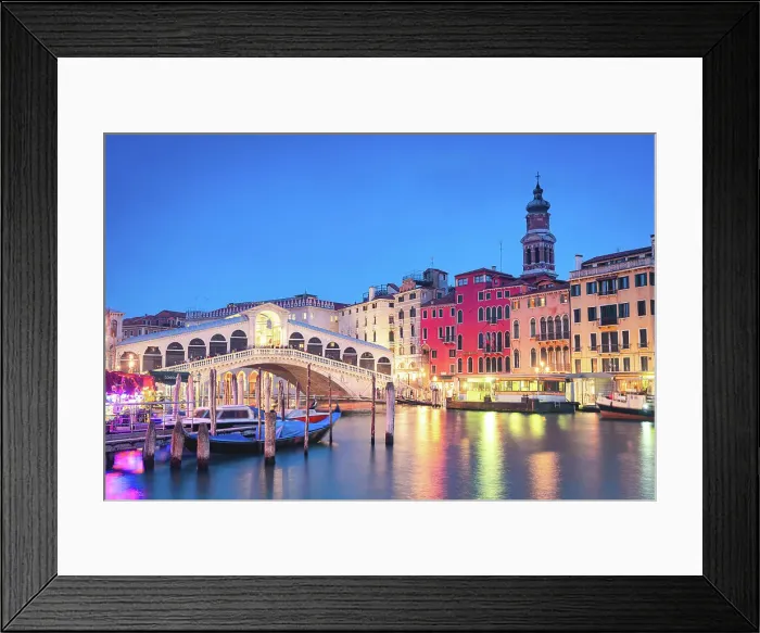 Framed Print : Illuminated buildings and Rialto Bridge reflected in the Grand Canal with moored gondolas at blue hour, Venice, Veneto, Italy Framed Print : Illuminated buildings and Rialto Bridge reflected in the Grand Canal with moored gondolas at blue hour, Venice, Veneto, Italy