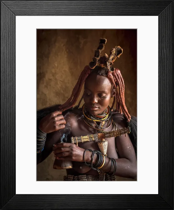 Framed Print : Africa, Namibia, Kamanjab. A himba woman preparing the herbal smoke to deodorize herself Framed Print : Africa, Namibia, Kamanjab. A himba woman preparing the herbal smoke to deodorize herself