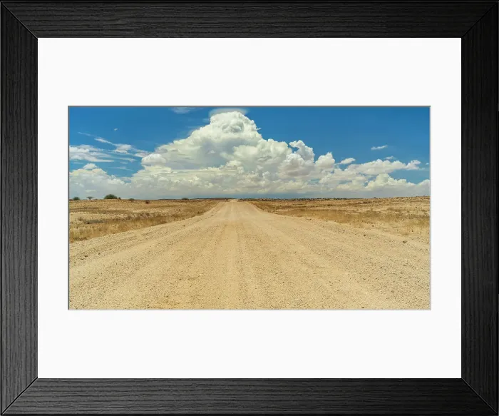 Framed Print : Africa, Namibia. A typical gravel road, straight, with a cloud building up Framed Print : Africa, Namibia. A typical gravel road, straight, with a cloud building up