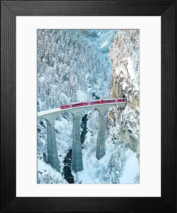 Framed Print : Train on Landwasser viaduct entering in a tunnel carved into a snowy mountain ridge, Filisur, Graubunden canton, Switzerland Framed Print : Train on Landwasser viaduct entering in a tunnel carved into a snowy mountain ridge, Filisur, Graubunden canton, Switzerland