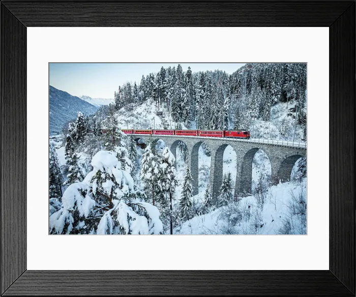 Framed Print : Iconic Swiss red train traveling in the snowy woods from Filisur to Tiefencastel railway station, Graubunden canton, Switzerland Framed Print : Iconic Swiss red train traveling in the snowy woods from Filisur to Tiefencastel railway station, Graubunden canton, Switzerland